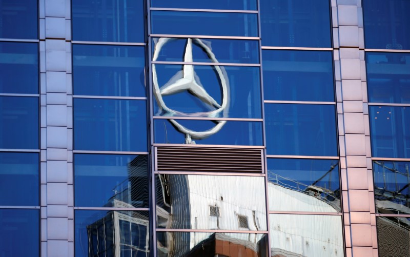 A Mercedes-Benz sign is seen reflected on a building in Warsaw