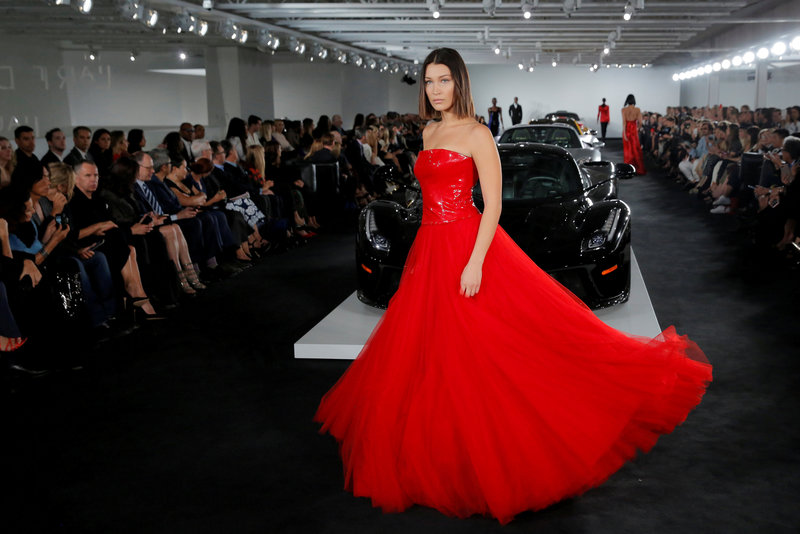 Model Bella Hadid presents a creation from the Ralph Lauren Spring/Summer 2018 collection in a show that was presented in Lauren's private garage for New York Fashion Week in Manhattan