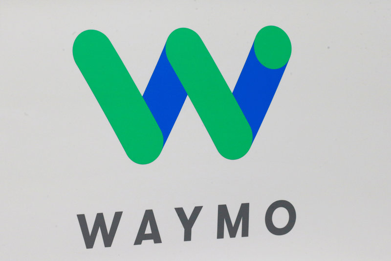 FILE PHOTO: The Waymo logo is displayed during the company's unveil of a self-driving Chrysler Pacifica minivan during the North American International Auto Show in Detroit