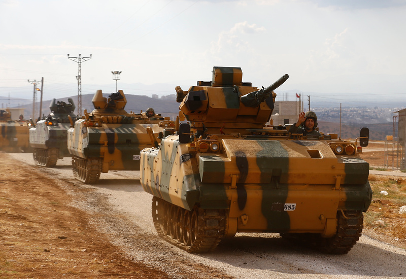 Turkish military convoy drives by village on Turkish-Syrian border line in Reyhanli