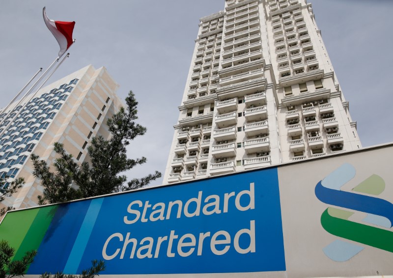 FILE PHOTO: A Standard Chartered sign is seen outside of a building, with a branch of the bank, in Jakarta, Indonesia