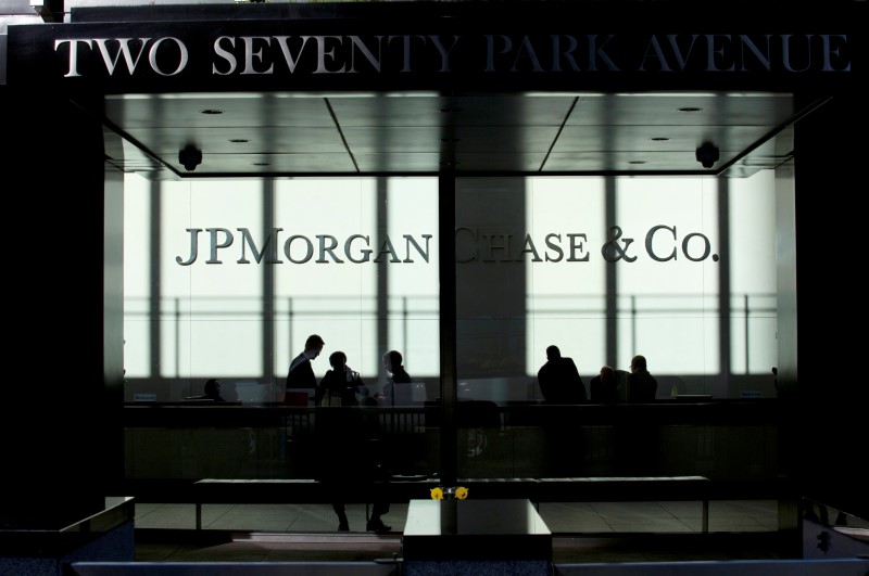 FILE PHOTO: People walk inside JP Morgan headquarters in New York