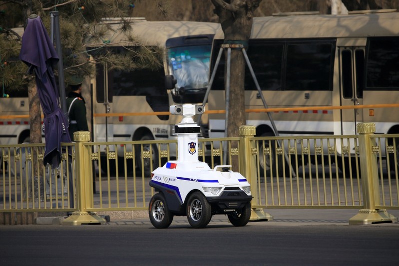FILE PHOTO: A police robot patrols before the third plenary session of the Chinese People's Political Consultative Conference (CPPCC) in Beijing