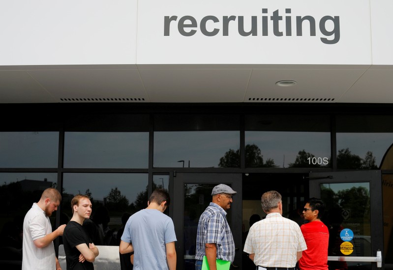 FILE PHOTO: Job seekers line up to apply during