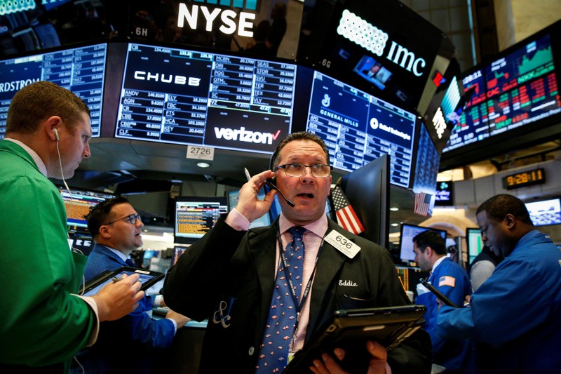 Traders work on the floor of the NYSE in New York