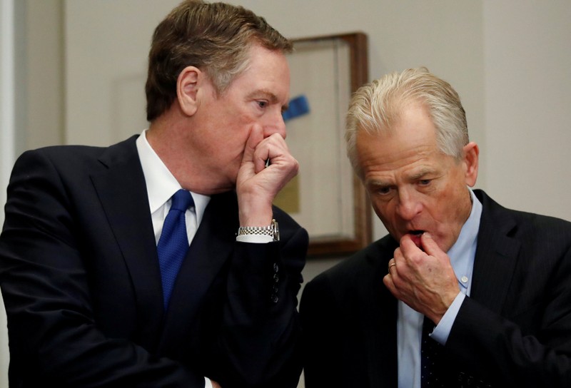 FILE PHOTO: Robert Lighthizer, United States Trade Representative, and Peter Navarro chat while they wait for U.S. President Donald Trump to arrive, at the White House in Washington