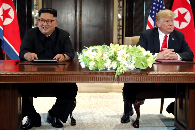 FILE PHOTO: U.S. President Trump and North Korea's Kim hold a signing ceremony at the conclusion of their summit in Singapore