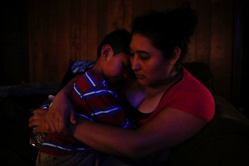 Morena Vasquez comforts her son Isai Rodriguez, 5, at their home in Rome, Georgia