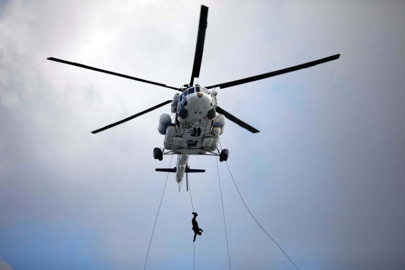 FILE PHOTO: A member of Special Weapon and Tactics (SWAT) rappels down during an anti-terror drill as a part of the Ulchi Freedom Guardian exercise in Goyang