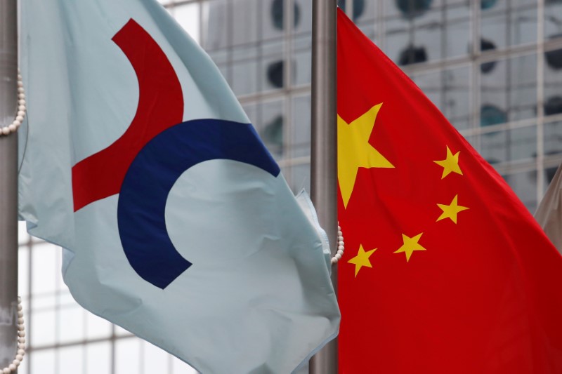 Hong Kong Exchanges flag hoisted beside Chinese national flag outside Hong Kong Stock Exchange