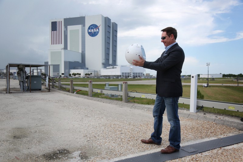 Bret Greenstein of IBM holds an artificial intelligence bot named CIMON, following a news conference at the Kennedy Space Center in Florida