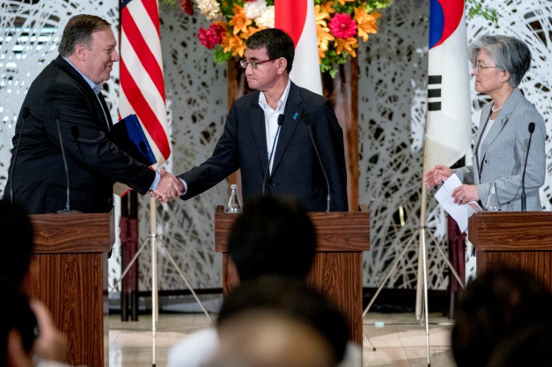 U.S. Secretary of State Mike Pompeo, Japan's Foreign Minister Taro Kono and South Korea's Foreign Minister Kang Kyung Wha speak with each other after a news conference in Tokyo