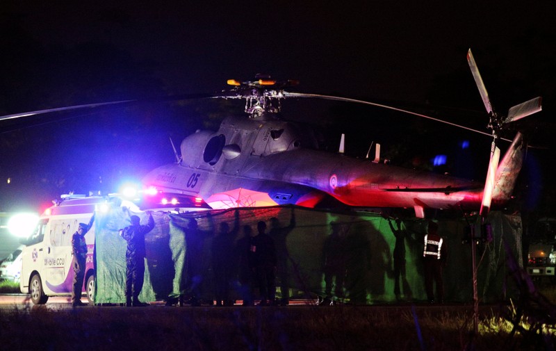 Rescued schoolboys are moved from a military helicopter to an awaiting ambulance at a military airport in Chiang Rai