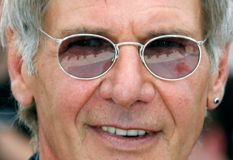 FILE PHOTO: Photographers are reflected in the glasses of cast member Ford at the 61st Cannes Film Festival in Cannes
