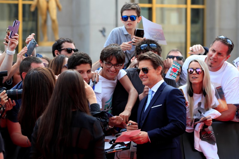 Cast member Tom Cruise poses for cinema fans as he arrives for the world premiere of