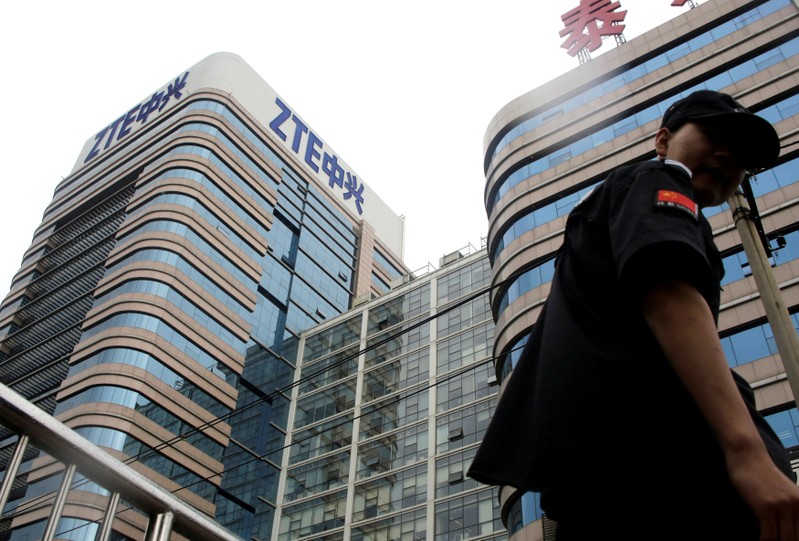 FILE PHOTO: A security guard walks past a building of ZTE Beijing research and development center in Beijing