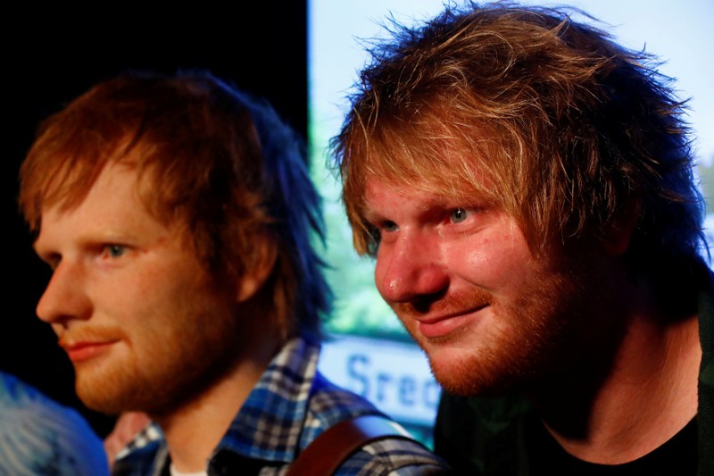 Nico Eckl, a lookalike of Ed Sheeran poses beside a wax figure of musician Ed Sheeran in the Madame Tussauds wax museum in Berlin