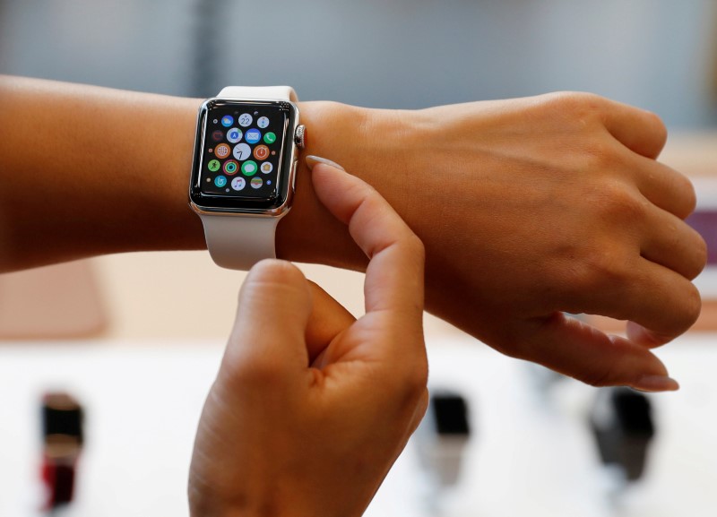 FILE PHOTO: A woman tries a new Apple Watch Series 3 Cellular model after it goes on sale at the Apple Store in Tokyo's Omotesando shopping district