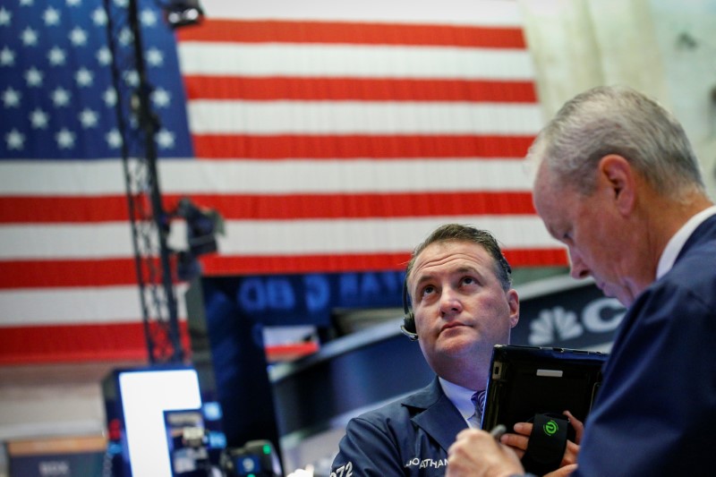 Traders work on the floor of the NYSE in New York