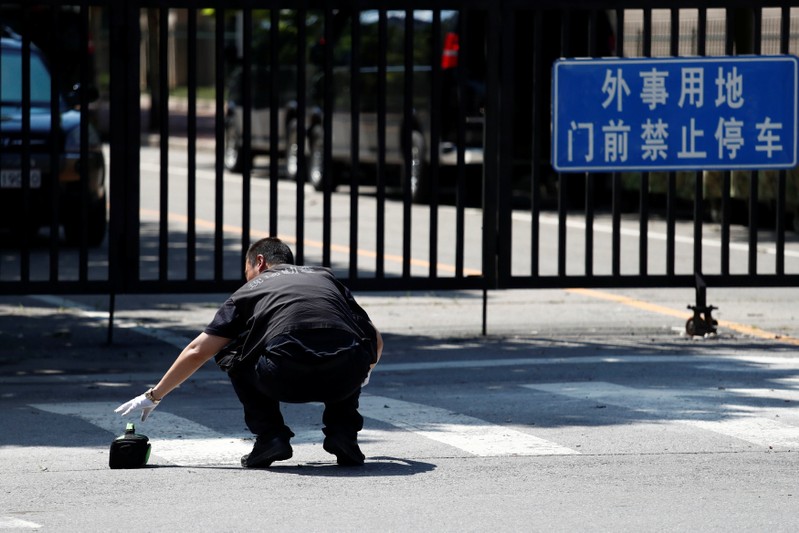 Security personnel is seen near the U.S. embassy in Beijing