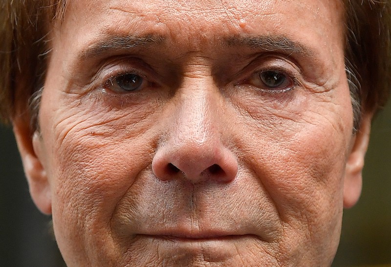Singer Cliff Richard leaves the High Court after the court found in his favor in the privacy case he brought against the BBC, in central London