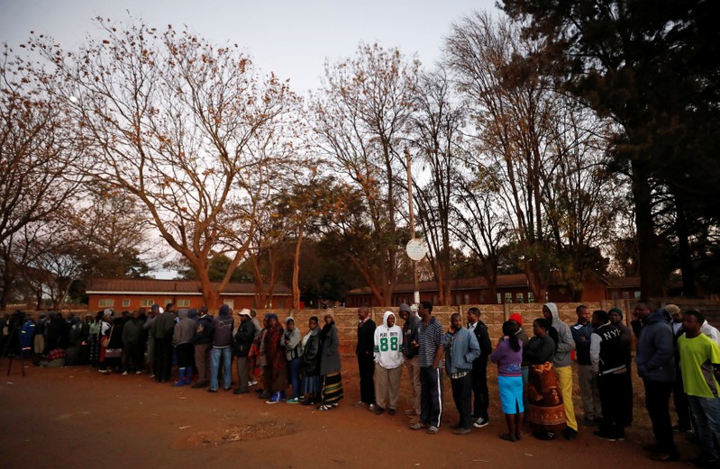 Zimbabwean voters queue to cast their ballots in the country's general elections in Harare