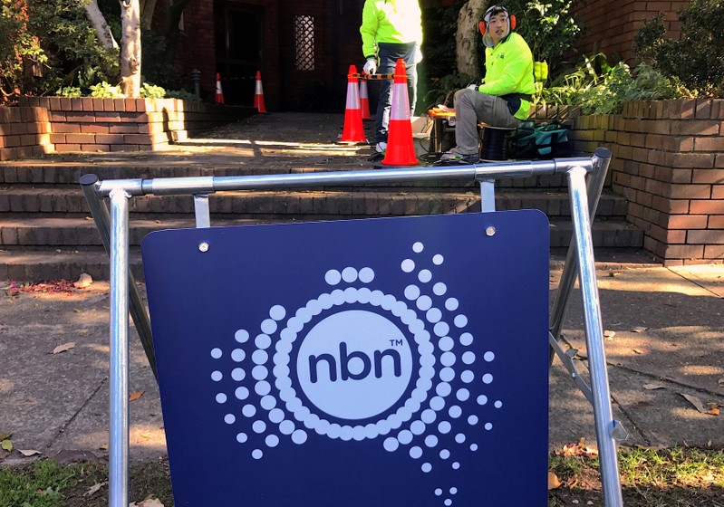 FILE PHOTO: Workers install cables for the Australian National Broadband Network at an apartment block in Sydney