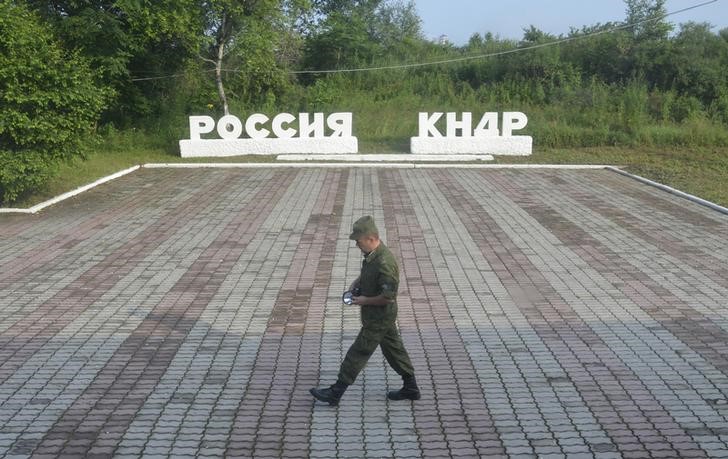 FILE PHOTO: A guard walks along the platform at the border crossing between Russia and North Korea at the North Korean settlement of Tumangan