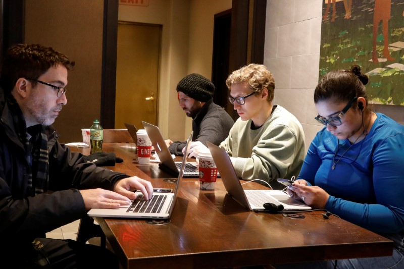 FILE PHOTO: Customers use the internet at a Starbucks in the financial district in New York