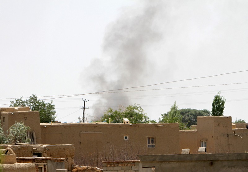Smoke rises from a residential area where gun battle is going on between Taliban and Afghan forces in Ghazni province
