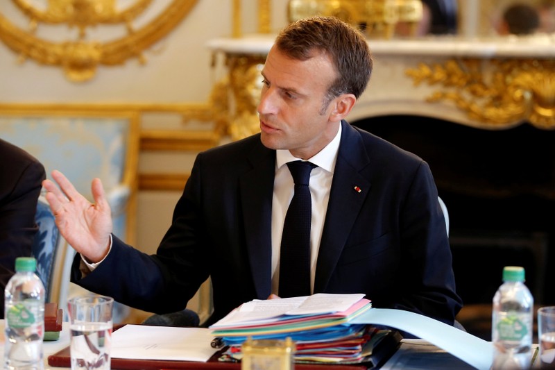 French President Emmanuel Macron gestures as he speaks during the last cabinet meeting before the government goes on holidays at the Elysee Palace in Paris