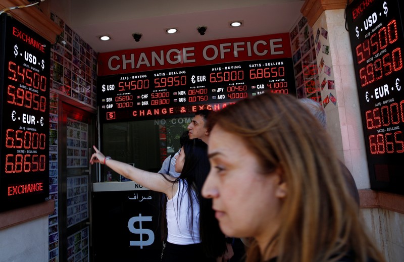 People check currency exchange rates at a currency exchange office in Istanbul