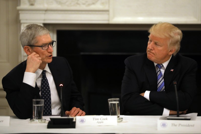 U.S. President Donald Trump listens as Tim Cook, CEO of Apple speaks during an American Technology Council roundtable at the White House in Washington, U.S.