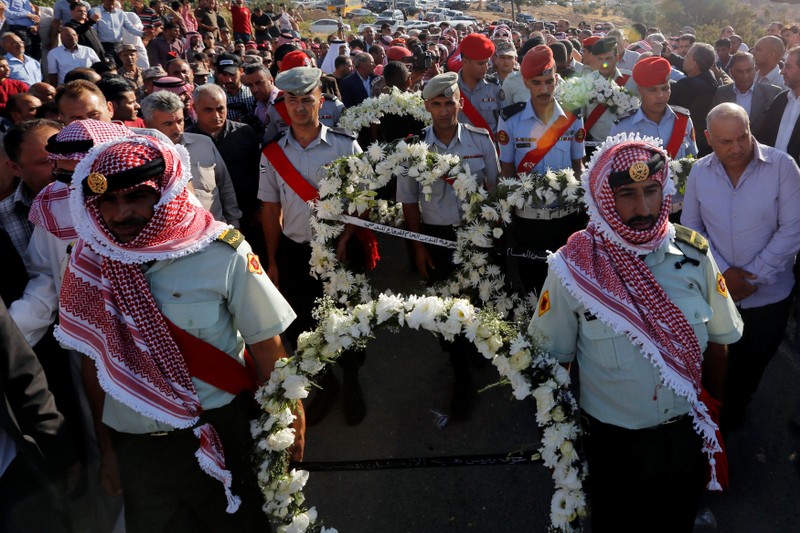 Guard of honor and relatives of Sergeant Hisham Aqarbeh, of the anti-terrorist unit, who was killed during an attack yesterday, attend his funeral in Birayn in the city of Zarqa