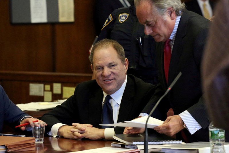 Weinstein speaks to his lawyer Benjamin Brafman inside Manhattan Criminal Court during an arraignment in the Manhattan borough of New York
