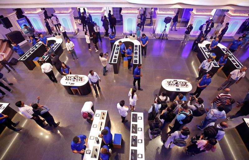 Staff members give media personnel a guided tour of the newly opened Samsung store in Bengaluru