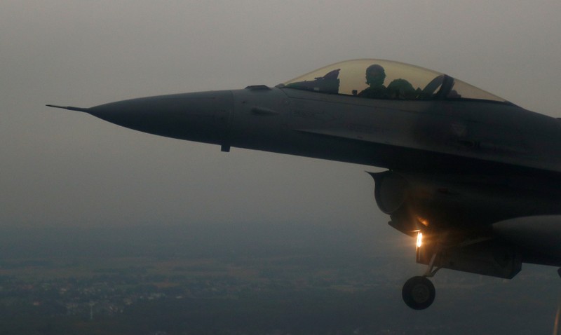 A Belgian F16 fighter plane demonstrates the interception of an air force transport plane as they fly over Belgium