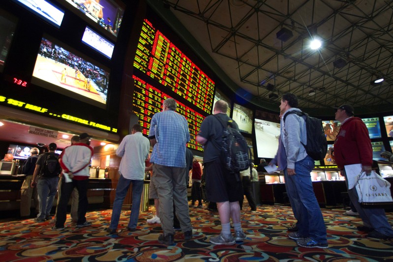 FILE PHOTO: People wait in line to place bets after Super Bowl XLVIII proposition bets were posted at the Las Vegas Hotel & Casino Superbook in Las Vegas