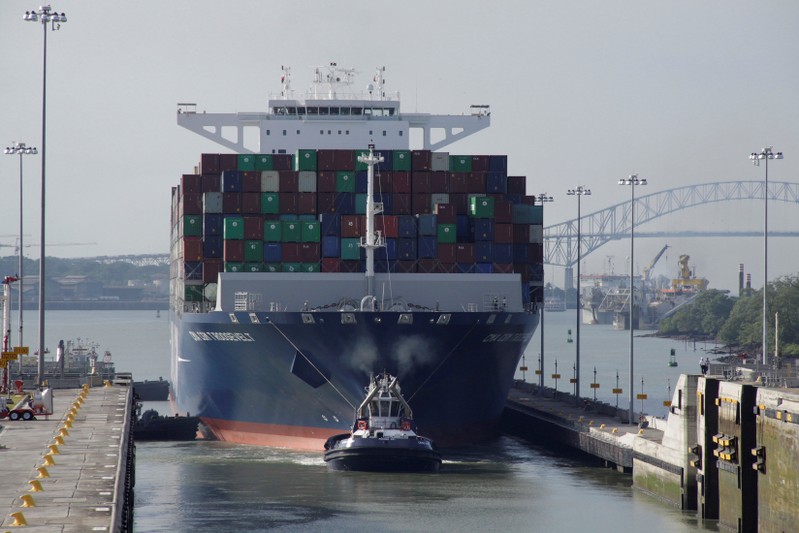 FILE PHOTO: Tugboat tows the British CMA CGM T. Roosevelt cargo vessel at Panama Canal