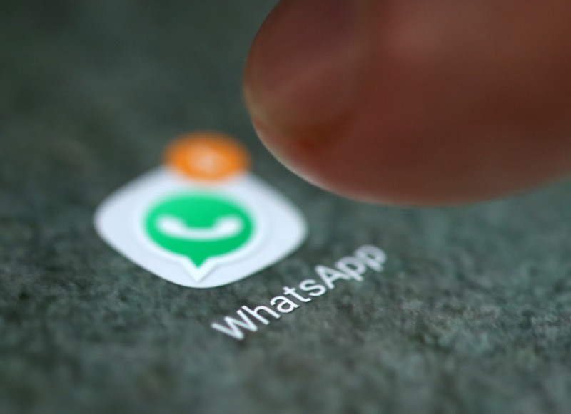 The WhatsApp app logo is seen on a smartphone in this illustration