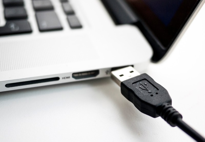 FILE PHOTO: Photo illustration shows USB device being plugged into a laptop computer in Berlin