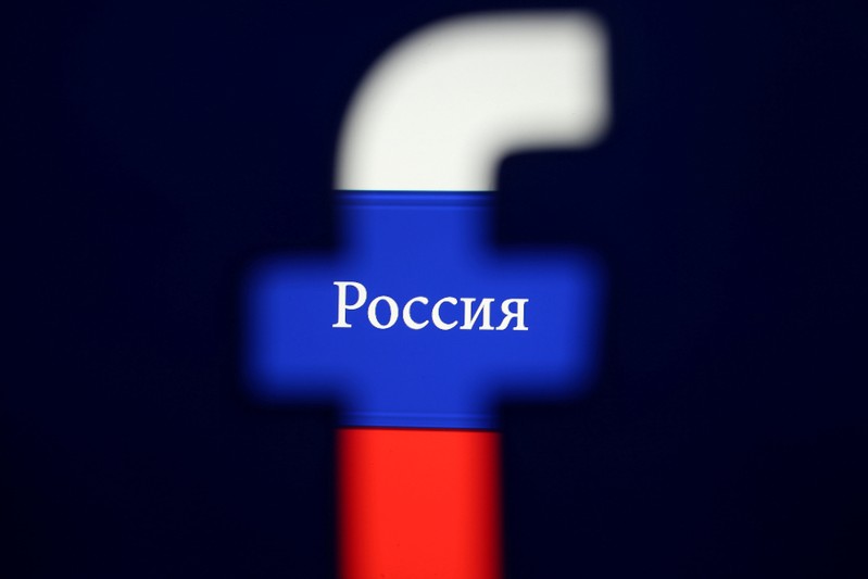 FILE PHOTO: Photo illustration of a 3D printed Facebook logo seen in front of a displayed Russian flag