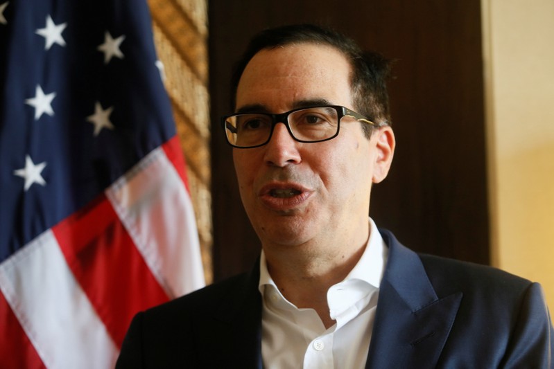 FILE PHOTO - United States Secretary of the Treasury Steven Mnuchin speaks during an interview with Reuters at the International Monetary Fund - World Bank Annual Meeting 2018 in Nusa Dua