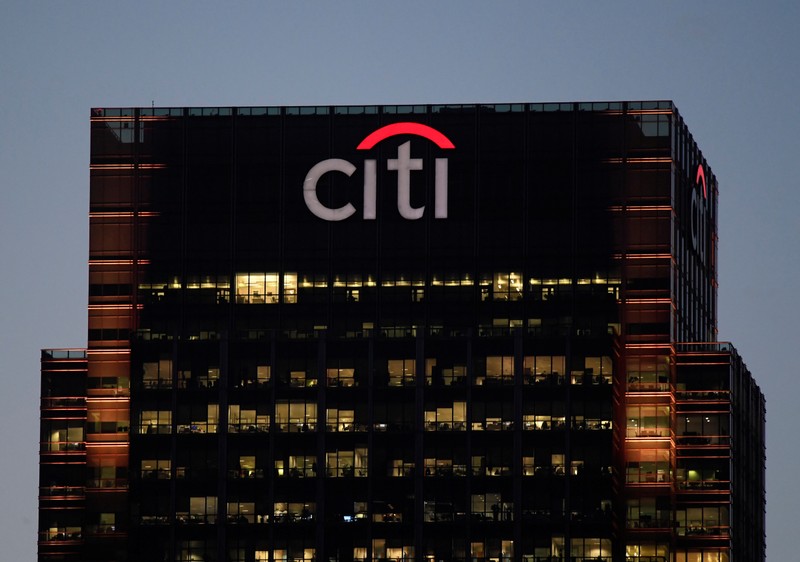 Workers are seen in at Citibank offices in the Canary Wharf financial district in London
