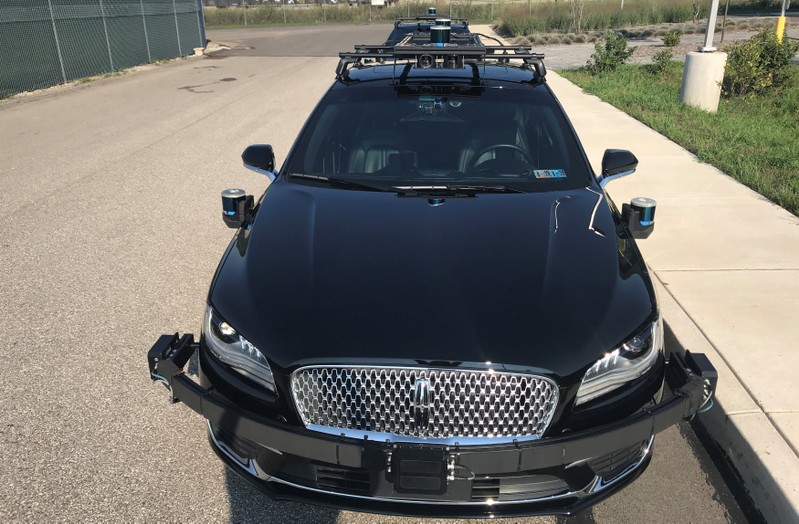 An Aurora self-driving Lincoln MKZ car is seen outside the company’s office in the Lawrenceville neighborhood in Pittsburgh