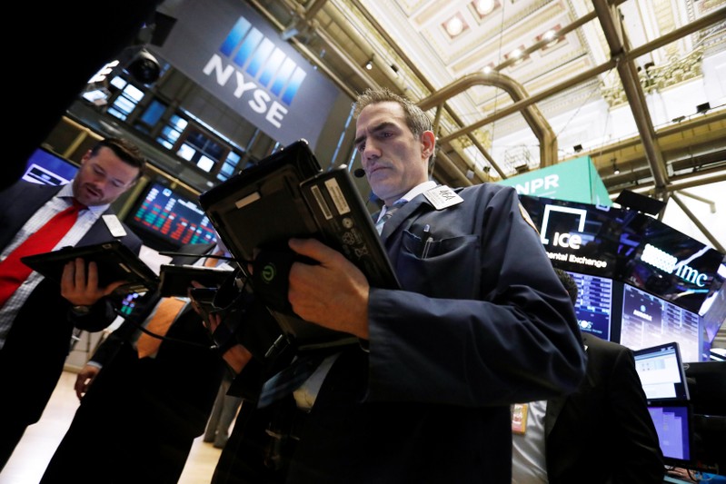 Traders work on the floor at the New York Stock Exchange (NYSE) in New York City