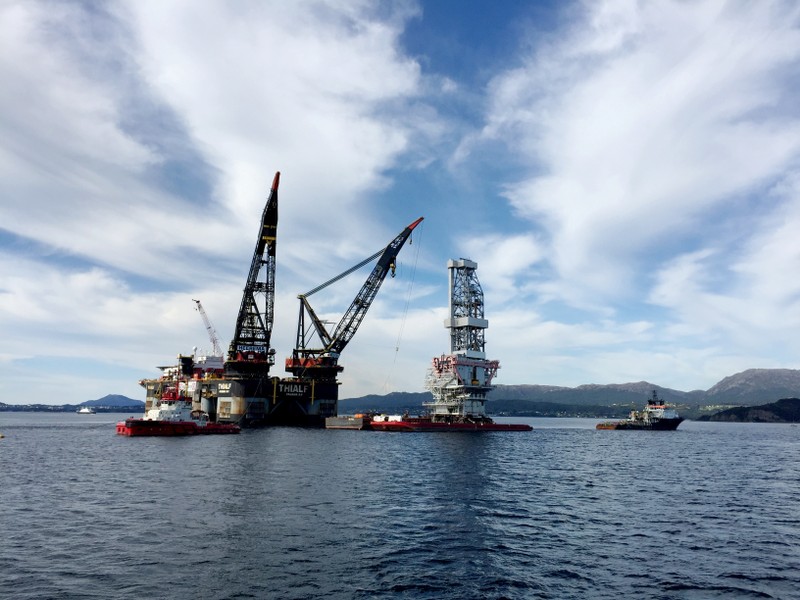 Oil careens lower on record Saudi production, global stock slide