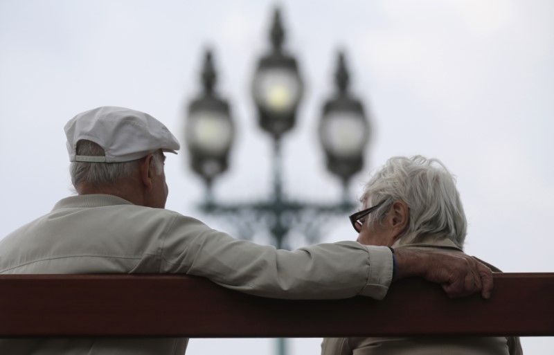 A retired couple sits on a bench in Enghien-les-Bains