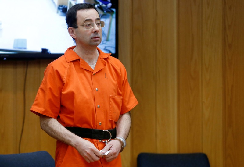 Larry Nassar, a former team USA Gymnastics doctor who pleaded guilty in November 2017 to sexual assault charges, stands in court during his sentencing hearing in the Eaton County Court in Charlotte