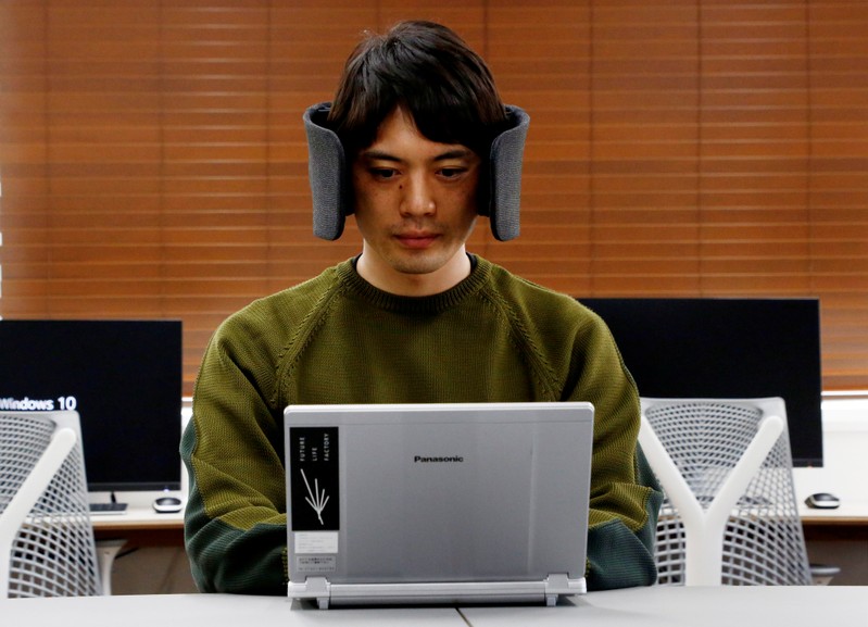 A designer of Panasonic demonstrates a prototype of 'Wear Space' during a photo opportunity in Tokyo